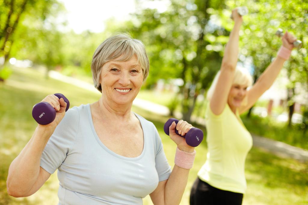 Pleasant mature females working out in the open air